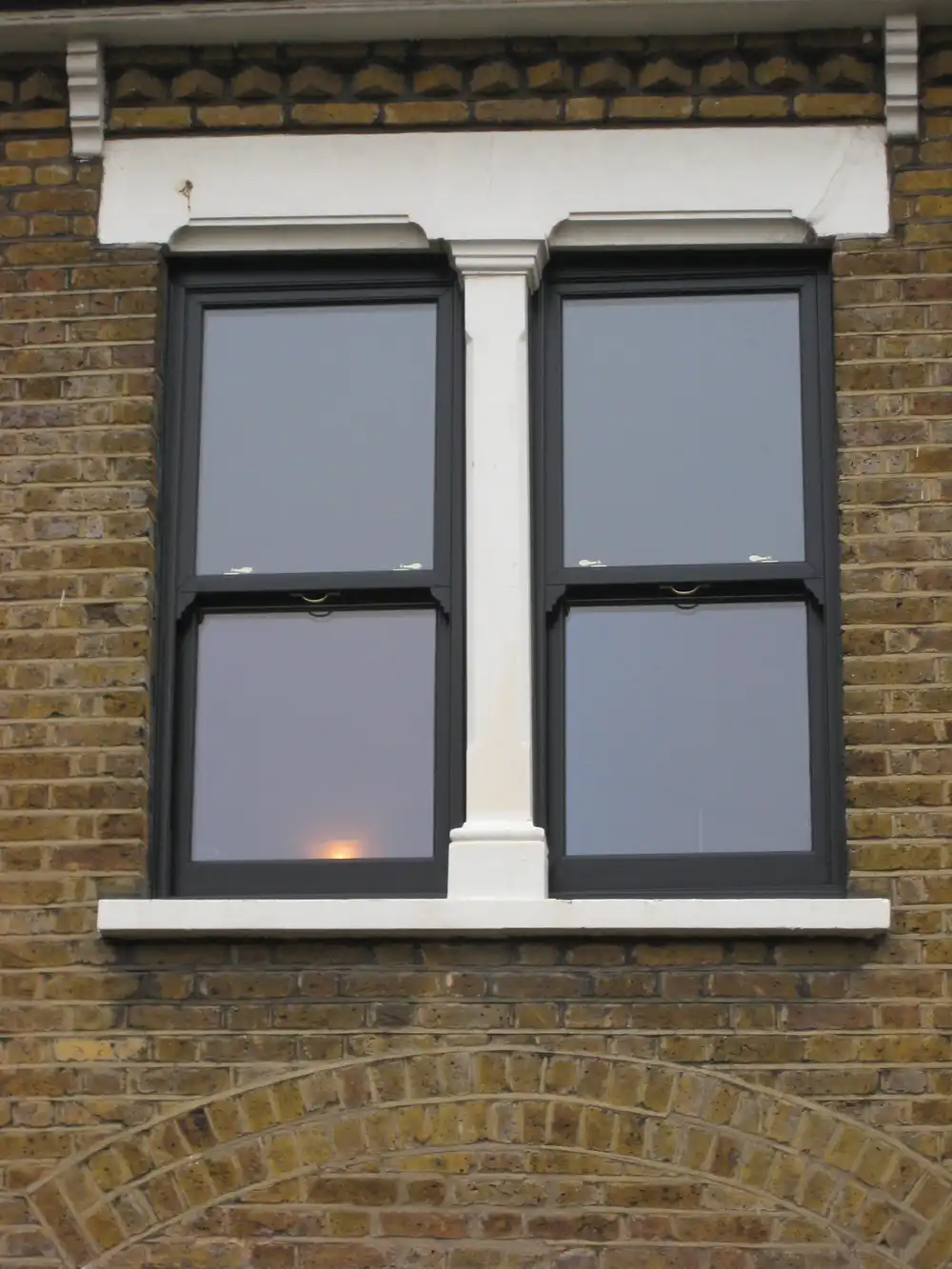 Black UPVC Vertical Slider Sash Windows on Brick Wall - Classic Contrast